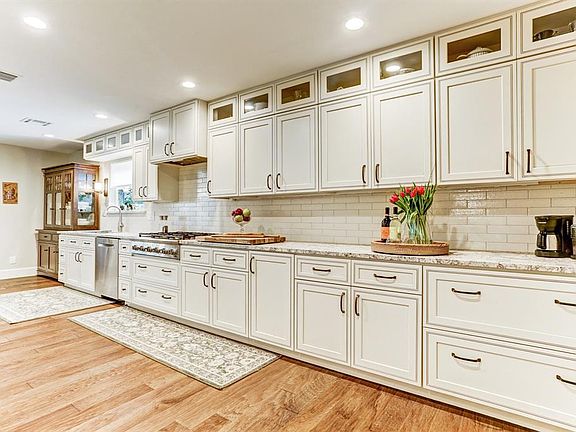 Wow!!! The chef's dream kitchen is elegantly appointed and ideally situated for entertaining. Custom cabinetry with an enormous amount of storage sweetens the pie.