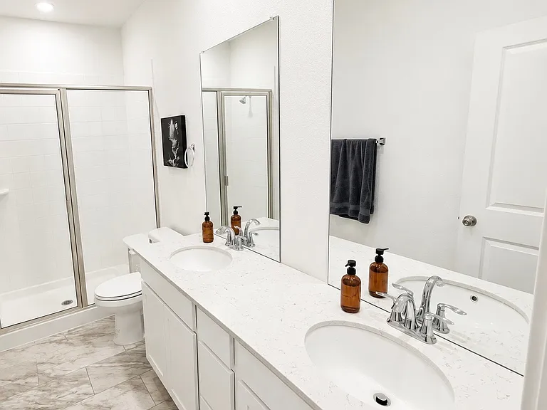 Primary bathroom, double vanity and walk-in shower.