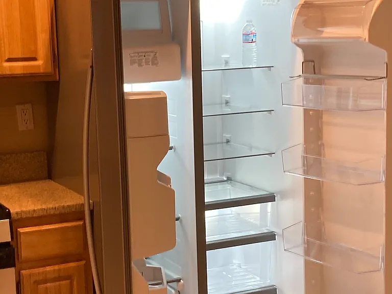Brand new refrigerator/freezer and extra working refrigerator/freezer in garage.