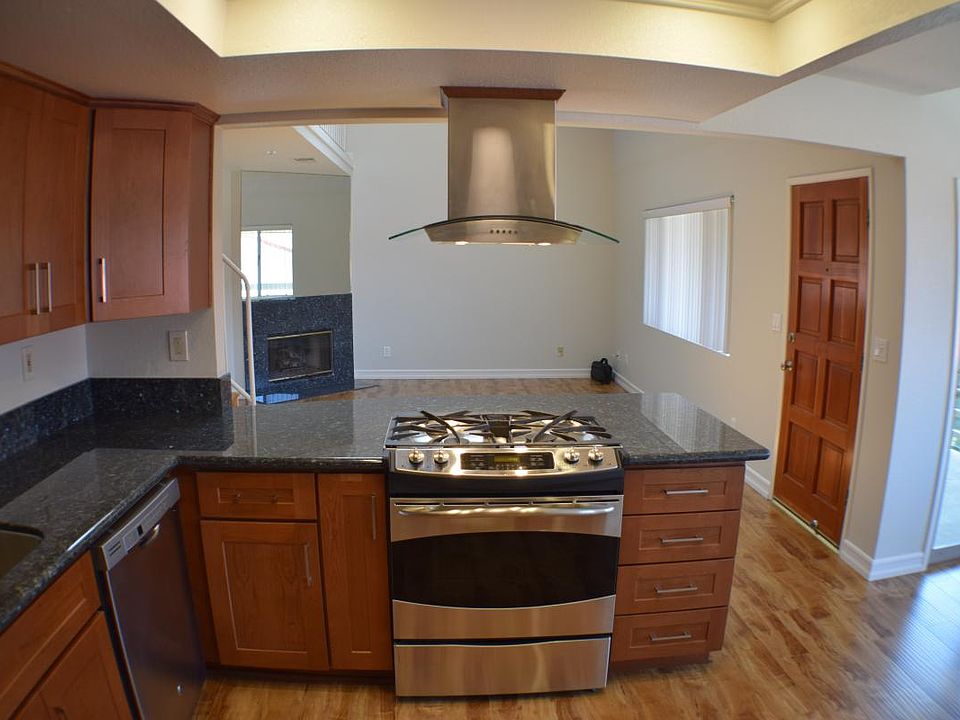 Kitchen looking into living room with balcony on the right