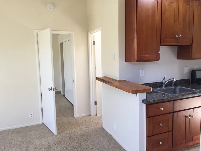 Doors to bedroom and bathroom off of living room.