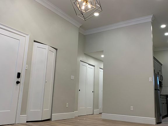 A 3rd shot of the living room, notice the abundant closet space and the openness to the kitchen.