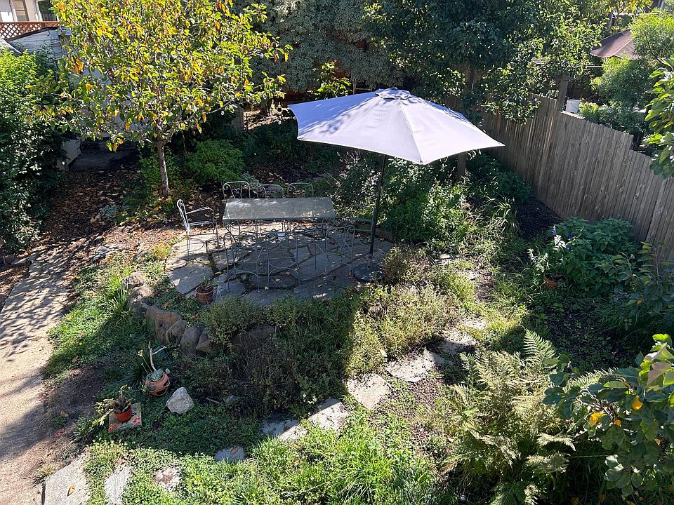 Backyard view from apartment deck; Outdoor dining area included in rental.