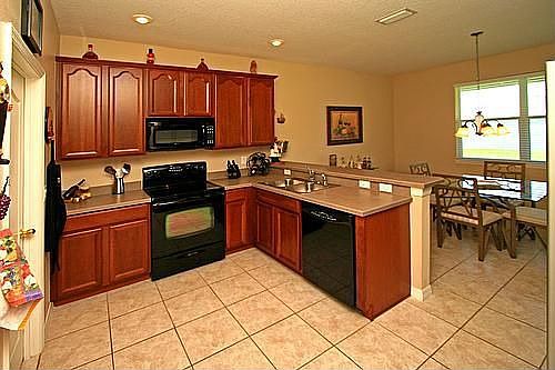 Beautiful, Rich Cabinetry and Black Appliances!
