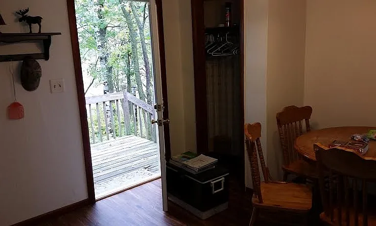 small back entrance with deck and lake view.