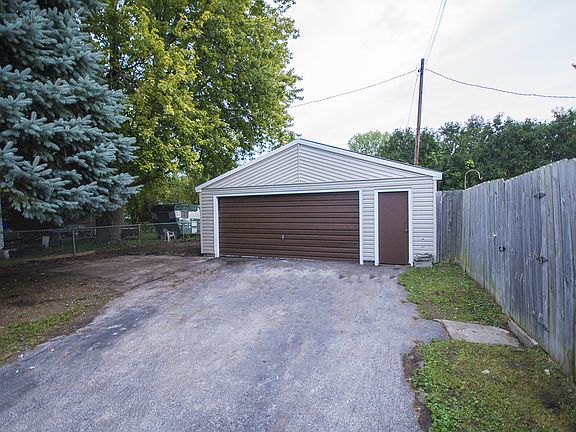 2.5 car garage with workshop also has a  new metal roof and entrance door from both front and fenced in backyard.  