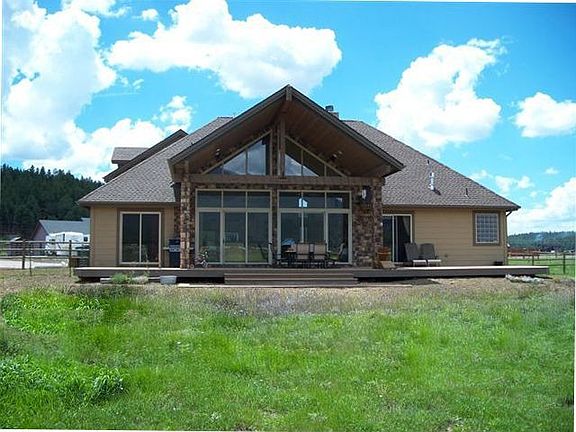 Fenced in back yard with large trex deck