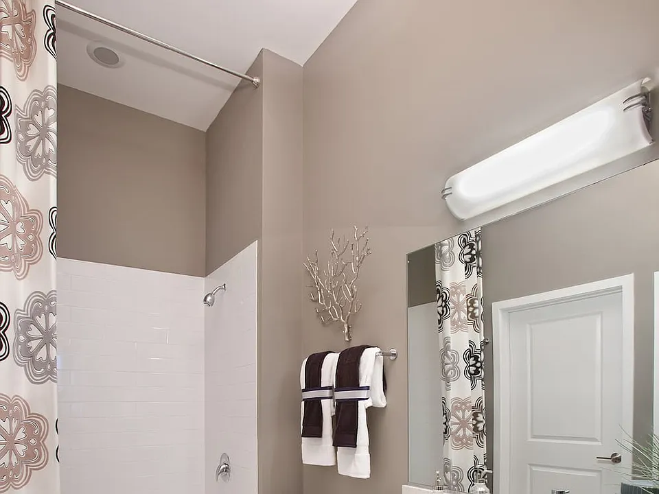 Bathroom with white quartz countertop, espresso cabinetry and hard surface flooring