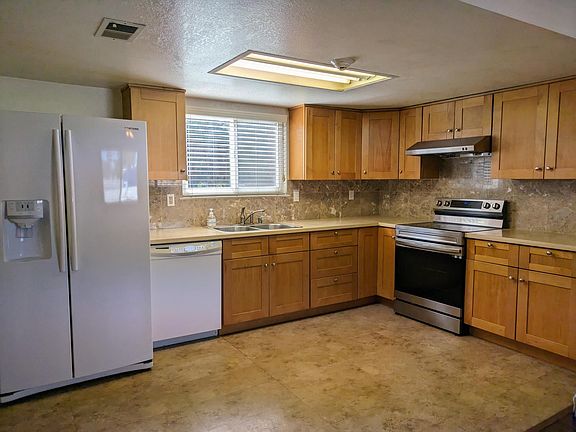 2nd Floor - Large open kitchen with ample cabinet space, refrigerator with ice-maker, and less than 1 year WIFI enabled stove/oven