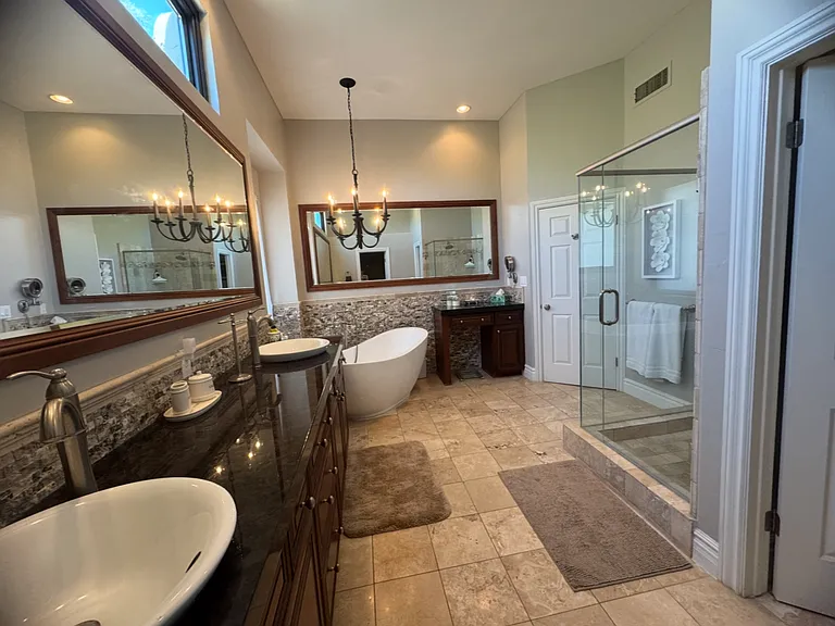 Primary bath: dual vanities, separate soaking tub, water closet, walk-in shower