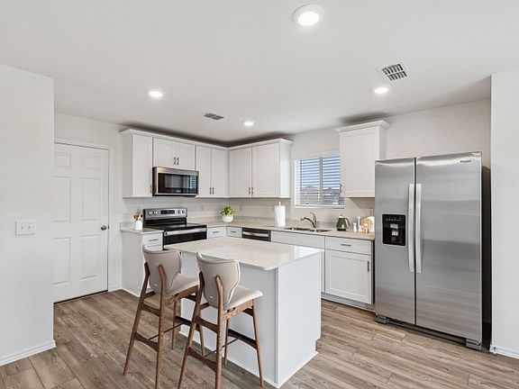 Kitchen featuring a large island ideal for informal dining and gatherings Model representation