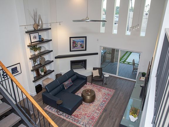 View of living room from second story. Notice the large vertical windows, they are equipped with a 22' tall electric shade.