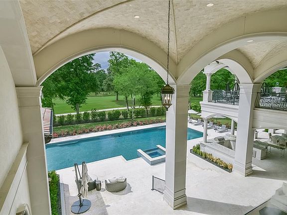 This view from the second floor of the home encompasses some of the spacious outdoor living spaces. The loggia from the master bedroom on the left leads across to the two story back lanai including two fireplaces, wet bar, summer kitchen and much more. Im