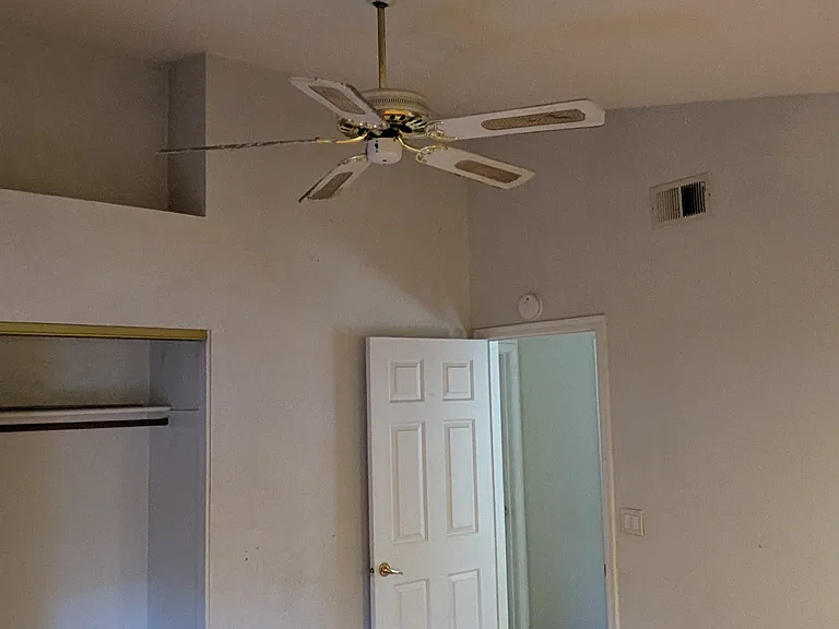 Bedroom 2 (upstairs) with window overlooking backyard