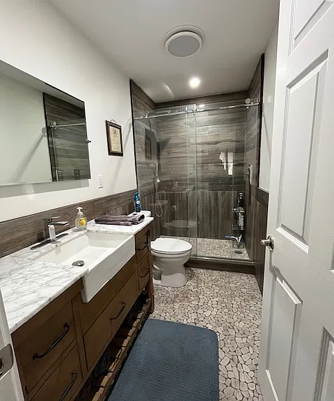 bathroom near bedrooms. Rain showerhead and radiant heat flooring.