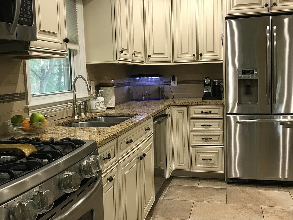 Granite counters, stainless appliances, French door refrigerator and back door to large covered and gated deck.