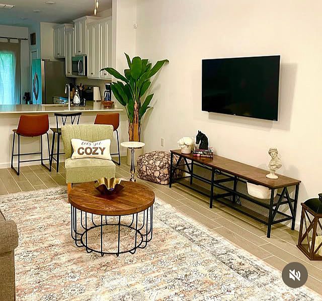 Relax and unwind in this inviting living room, featuring a cozy couch, sitting chairs and a coffee table perfect for conversations or movie nights.