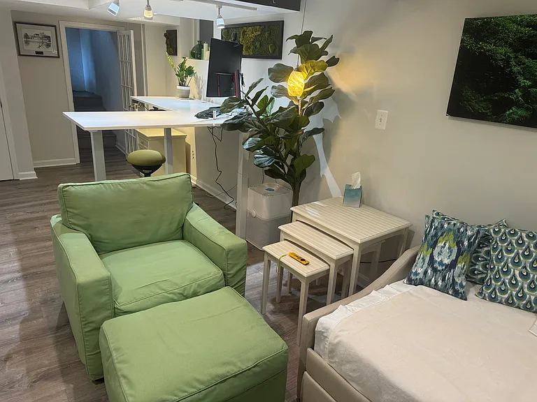 Seating area, air purifier, soft lights, and desk view.