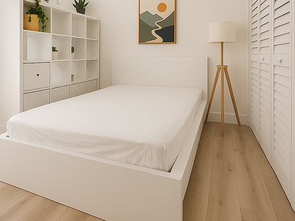Full-size bed with plenty of storage in closet and freestanding shelf divider.