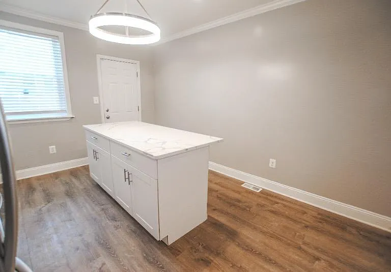 Walk in to an open first level; head to the back of the house to find the upgraded kitchen