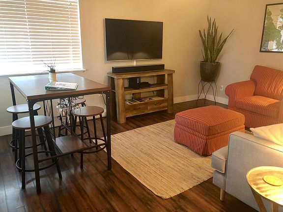Living/dining area has space for seating and a breakfast nook. Ceiling fan as well.