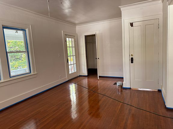 Living room showing the entrance door on the right, Closet, and french door to covered deck.