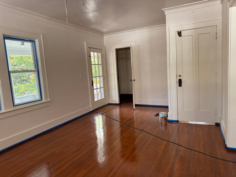 Living room showing the entrance door on the right, Closet, and french door to covered deck.