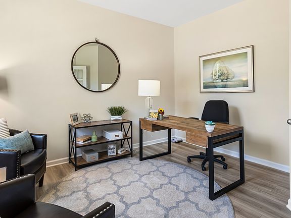 Open Flex room with 2 large windows, light toned wood floors, and white french doors in Canterbury S