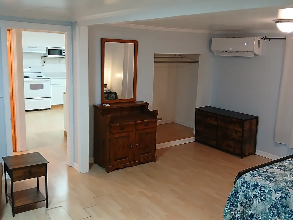 view to mini hall with desk, closet and entries into bathroom and kitchen