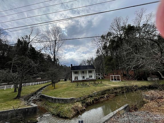 Stately Home Surrounded On Two Sides By The Serene Mountain Stream