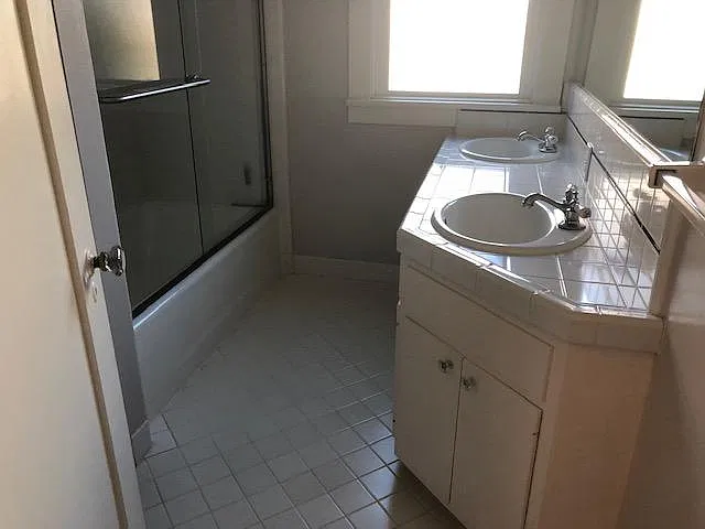 Bathroom with double sinks and full bath
