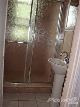New 3/4 Bath, Ceramic Tile Floor, Shower with Sliding Glass Doors and Lavatory.    Also Commode in Basement