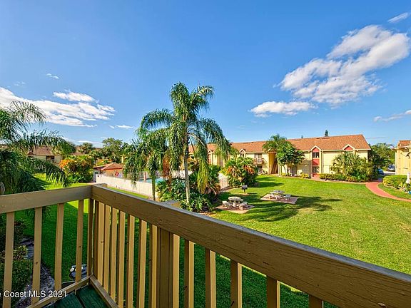 Balcony overlooking courtyard and pool