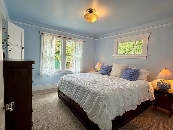 Bedroom 1- showing king bed and dresser in the space.