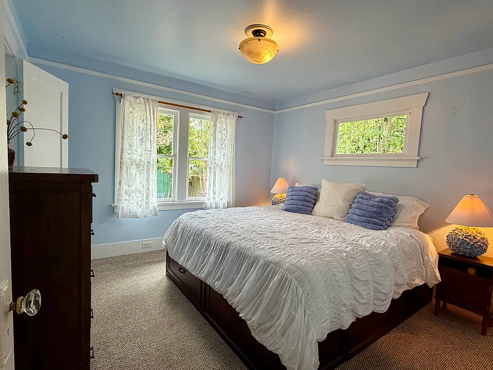 Bedroom 1- showing king bed and dresser in the space.