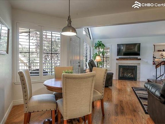 Dining table with view of TV and Gas Fireplac