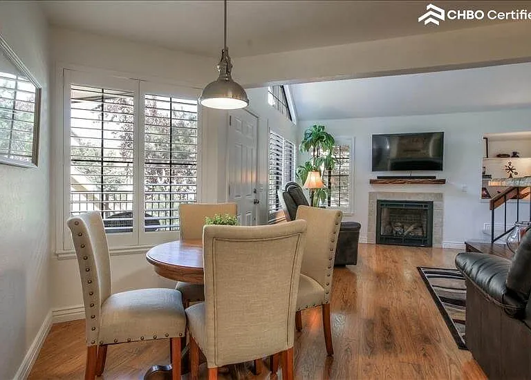 Dining table with view of TV and Gas Fireplac