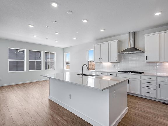 Gourmet kitchen with white cabinetry and quartz counter tops