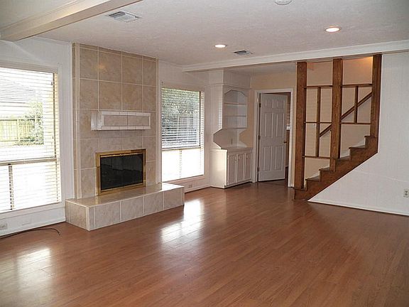  View of den in other direction, showing stairs to second floor and entrance to master bedroom suite.