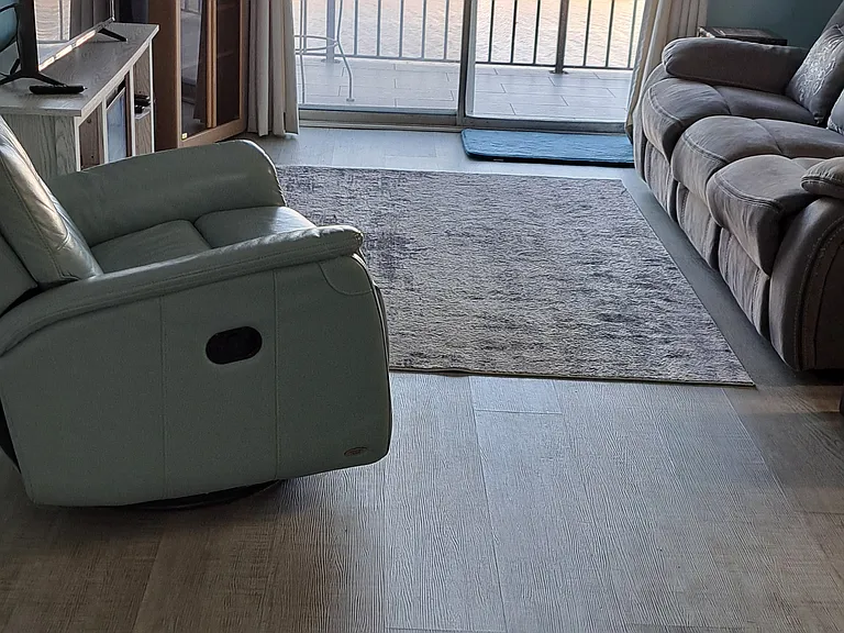 Living room with sliding door and view of waterway.