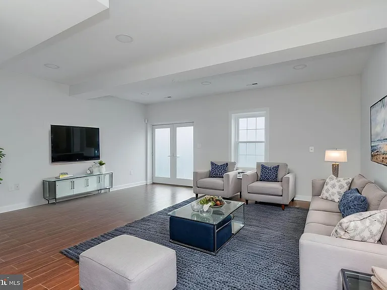 Staged basement living space. Exit to backyard