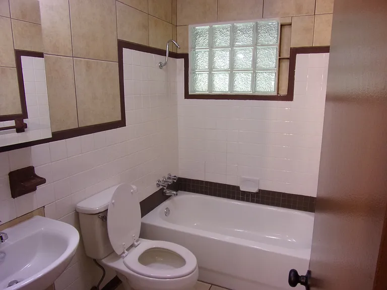 HALL BATHROOM - CLOSE TO 2ND AND 3RD BEDROOMS - TILED WALLS (EASY TO KEEP CLEAN) - NEW MIRRORED CABINET - GLASS BLOCK WINDOW