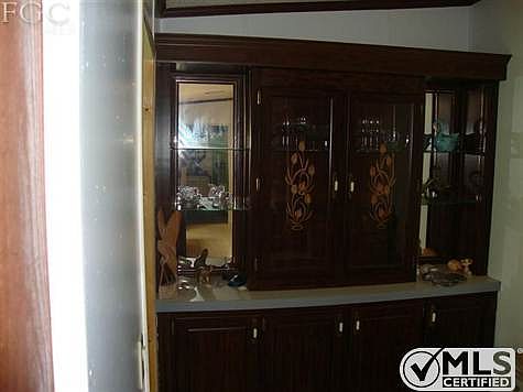 This storage area is located off of the kitchen and has an island.