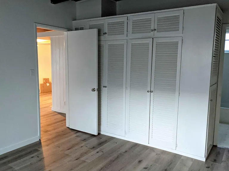 Bedroom showing large main closet plus the linen closet near the door to the bathroom.