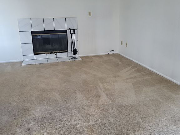 Wood burning fireplace in living room.