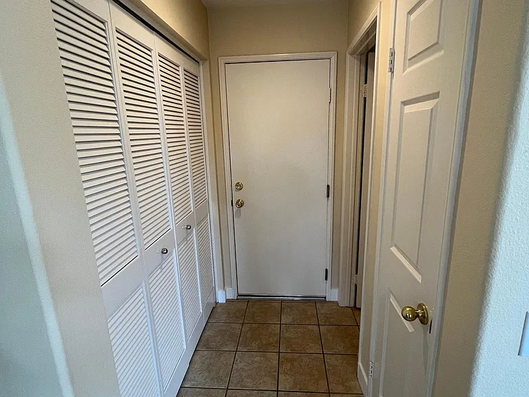 Convenient laundry closet, garage access, guest bathroom, and coat closet