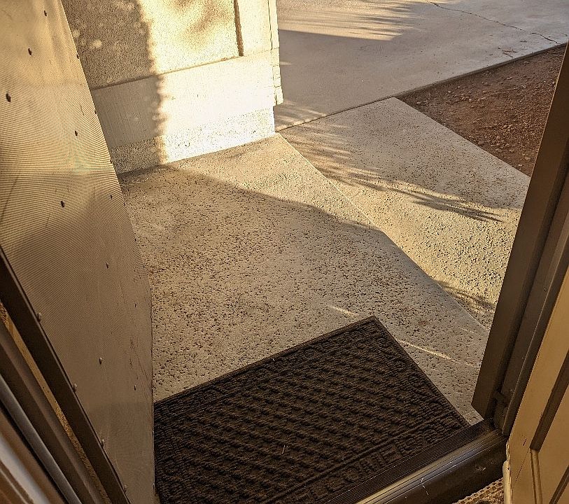 Security screen door open, entry door has an electronic lock with code
