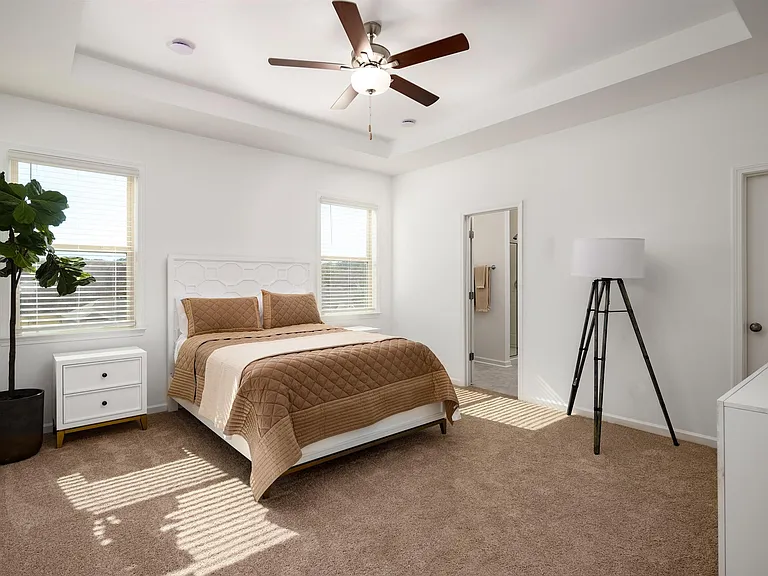 Primary Bedroom with king size bed and large window letting in nice natural light.