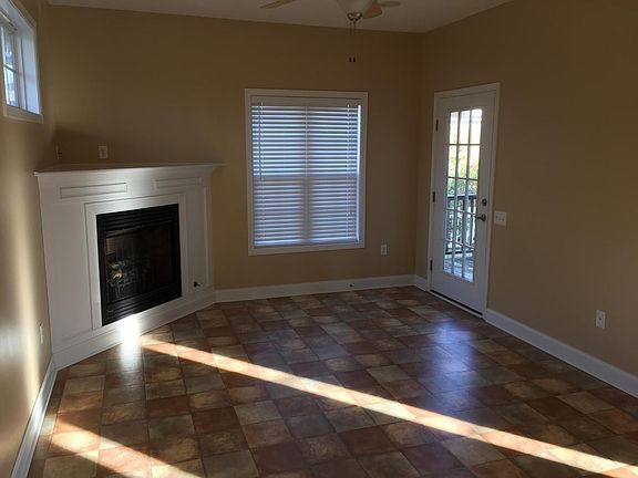 Open living room with fireplace and access to backyard.