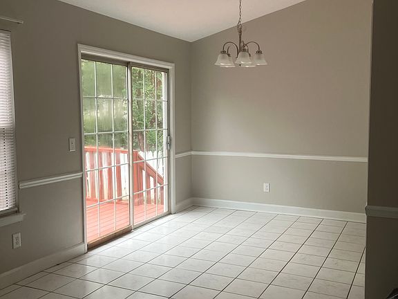 Large Dining Room with Tile Flooring and Natural Light.